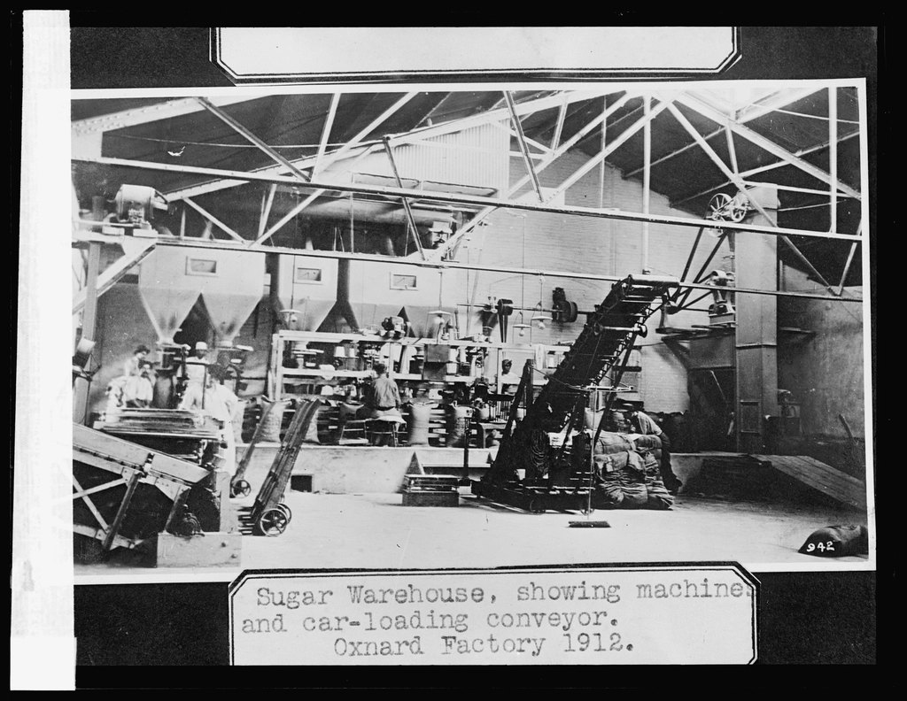Sugar warehouse, showing machines car-loading